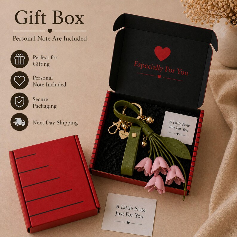 Luxury botanical leather bag charm featuring blush pink leather flowers, olive green leather leaves, decorative tassel, wrist loop, premium gold hardware, and elegant handbag accessory. Handmade floral purse charm designed for luxury handbags, designer inspired totes, shoulder bags, crossbody purses, woven beach bags, and everyday handbags. Arrives beautifully packaged in a signature gift box, making a ready to gift birthday gift, Mother's Day gift, bridesmaid gift, Christmas gift for women.