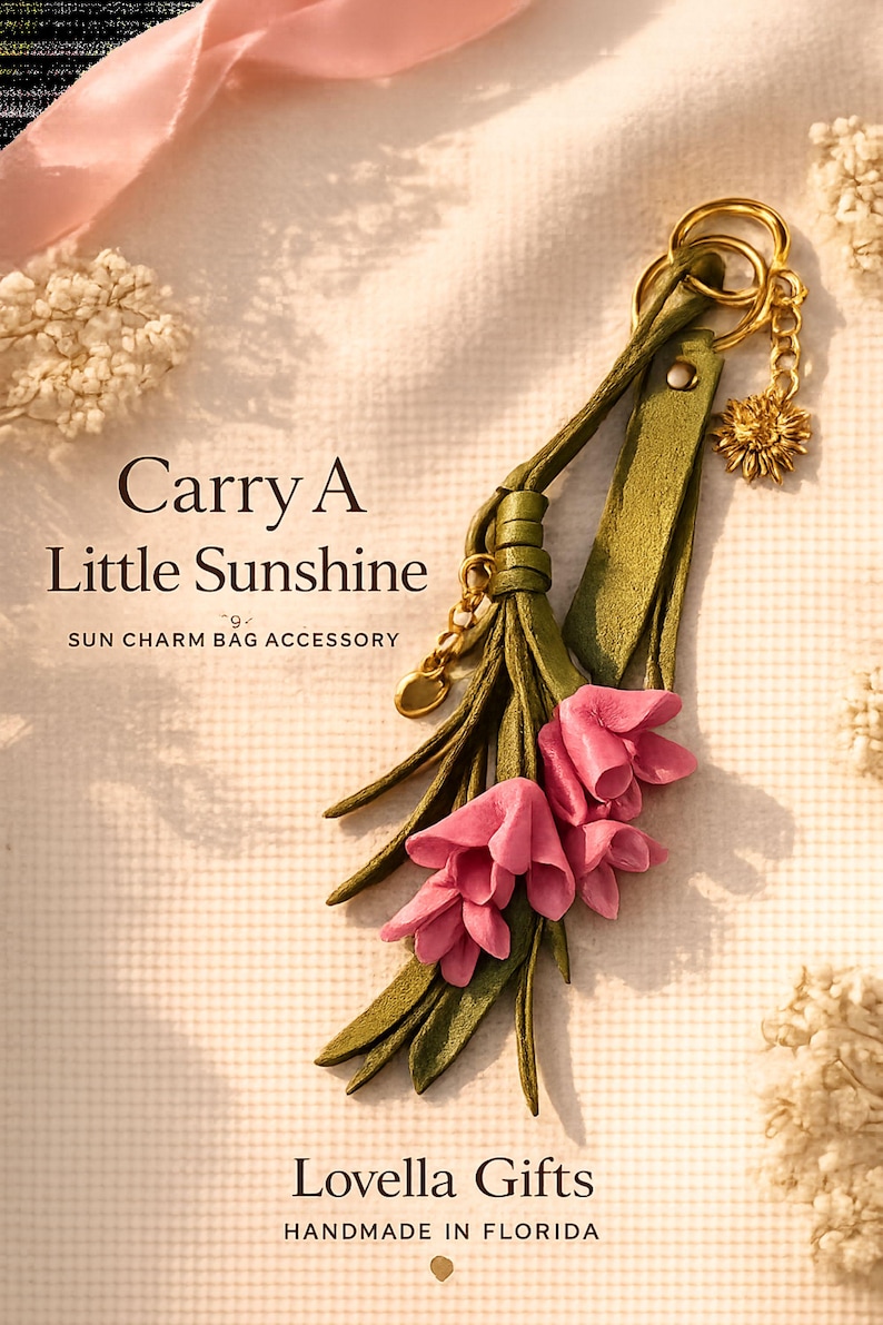 Handmade sunflower bag charm featuring soft pink leather flowers, olive green leather tassel, premium gold sunflower charm and luxury gold hardware. Botanical handbag accessory designed for tote bags, leather handbags, shoulder bags, crossbody bags, straw bags, beach bags and backpacks. Cottagecore purse charm inspired by nature and garden style. Floral bag jewelry, handmade leather keychain, lightweight purse decoration, gift for women, Mother's Day gift, birthday gift, bridesmaid gift.