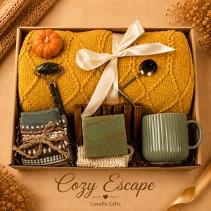 Fall gift box for women, handmade pumpkin soy candle, ceramic mug, artisan soap, decorative glass match bottle, plush teddy bear and cozy autumn socks beautifully arranged in boutique gift packaging. Cozy gift basket and autumn care package perfect as a blanket gift, hygge self care gift, comfort gift, thinking of you gift, appreciation gift, housewarming gift, Thanksgiving hostess gift, birthday gift, get well soon gift and seasonal gift for mom, grandma, sister, friend or coworker.