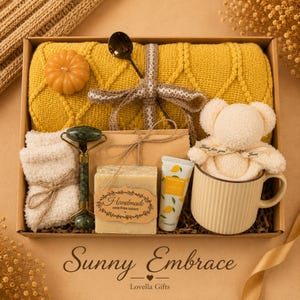 Fall gift box for women, handmade pumpkin soy candle, ceramic mug, artisan soap, decorative glass match bottle, plush teddy bear and cozy autumn socks beautifully arranged in boutique gift packaging. Cozy gift basket and autumn care package perfect as a blanket gift, hygge self care gift, comfort gift, thinking of you gift, appreciation gift, housewarming gift, Thanksgiving hostess gift, birthday gift, get well soon gift and seasonal gift for mom, grandma, sister, friend or coworker.