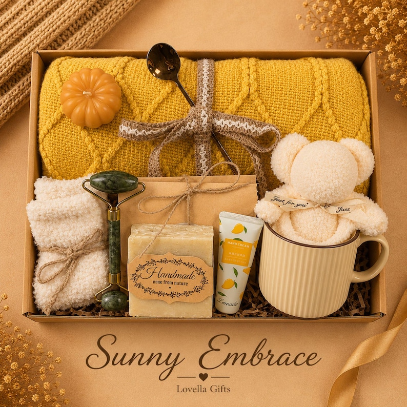 Fall gift box for women, handmade pumpkin soy candle, ceramic mug, artisan soap, decorative glass match bottle, plush teddy bear and cozy autumn socks beautifully arranged in boutique gift packaging. Cozy gift basket and autumn care package perfect as a blanket gift, hygge self care gift, comfort gift, thinking of you gift, appreciation gift, housewarming gift, Thanksgiving hostess gift, birthday gift, get well soon gift and seasonal gift for mom, grandma, sister, friend or coworker.