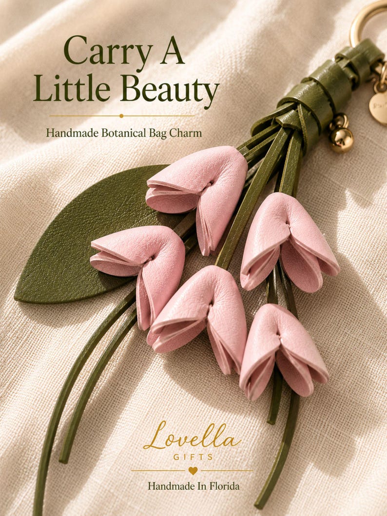 Luxury botanical leather bag charm featuring blush pink leather flowers, olive green leather leaves, decorative tassel, wrist loop, premium gold hardware, and elegant handbag accessory. Handmade floral purse charm designed for luxury handbags, designer inspired totes, shoulder bags, crossbody purses, woven beach bags, and everyday handbags. Arrives beautifully packaged in a signature gift box, making a ready to gift birthday gift, Mother's Day gift, bridesmaid gift, Christmas gift for women.