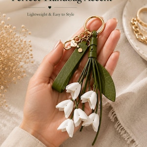 White floral bag charm with leather flowers and gold hardware, elegant purse charm accessory for women, luxury handbag charm with tassel, aesthetic white keychain for tote bag, trendy flower purse accessory, feminine handbag decoration, modern leather floral keychain, gift for her, cute white purse charm, boutique style bag accessory, minimal elegant keychain for handbags, stylish floral charm for purse, luxury fashion bag accessory