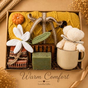 Fall gift box for women, handmade pumpkin soy candle, ceramic mug, artisan soap, decorative glass match bottle, plush teddy bear and cozy autumn socks beautifully arranged in boutique gift packaging. Cozy gift basket and autumn care package perfect as a blanket gift, hygge self care gift, comfort gift, thinking of you gift, appreciation gift, housewarming gift, Thanksgiving hostess gift, birthday gift, get well soon gift and seasonal gift for mom, grandma, sister, friend or coworker.