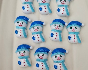 May include: Ten white snowman ornaments with blue hats and scarves. The snowmen have black eyes, red cheeks, and a small black mouth. The ornaments are perfect for decorating a Christmas tree or adding a festive touch to any winter decor.
