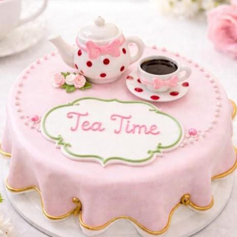 May include: A round cake covered in smooth light pink fondant with a scalloped gold-trimmed edge. Centered is a white plaque with the text Tea Time in pink script. Atop the cake sits a white teapot with red polka dots and a pink bow, plus a matching teacup.