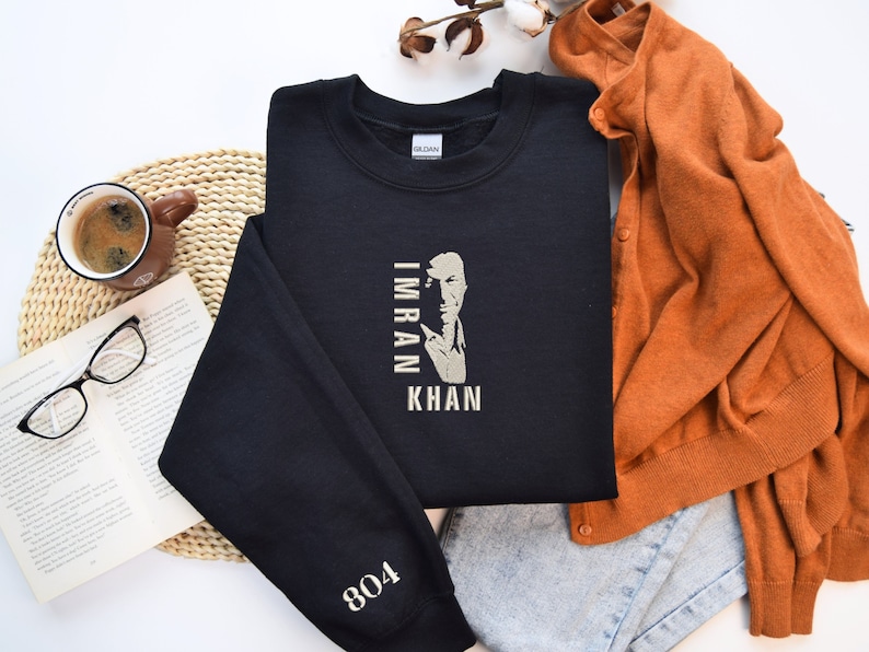 May include: Black sweatshirt with a portrait of Imran Khan and the text "Imran Khan" in white. The sweatshirt has a white 804 on the sleeve.