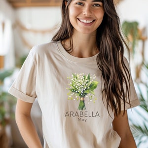 Add a touch of nature to your wardrobe with our customizable design featuring your first name, birth month flower, and birth month. Whether you are a lover of flowers or searching for a unique and meaningful gift for Mothers Day or bridesmaid gifts.