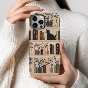 Embrace books and nature with our Bookish Boho Floral Phone Case.  Designed with book lovers in mind, this faux embroidery cat on bookshelf phone case features a flat surface print of shelved books, a cat and flowers on a vintage look background