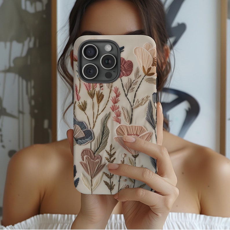 Embrace the beauty of nature with our Retro Floral Faux Embroidery Phone Case.  Designed with nature in mind, this bohemian flowers phone case features a flat surface print of flowers on a vintage look background