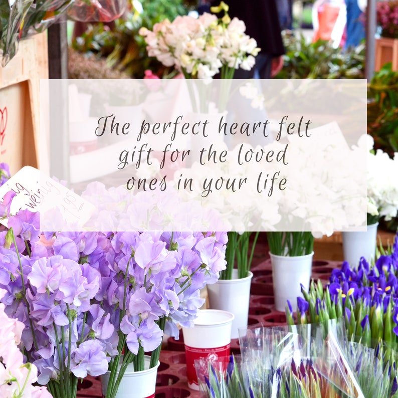 May include: A bouquet of purple and white sweet pea flowers in white cups. The text "The perfect heart felt gift for the loved ones in your life" is on a white rectangle.