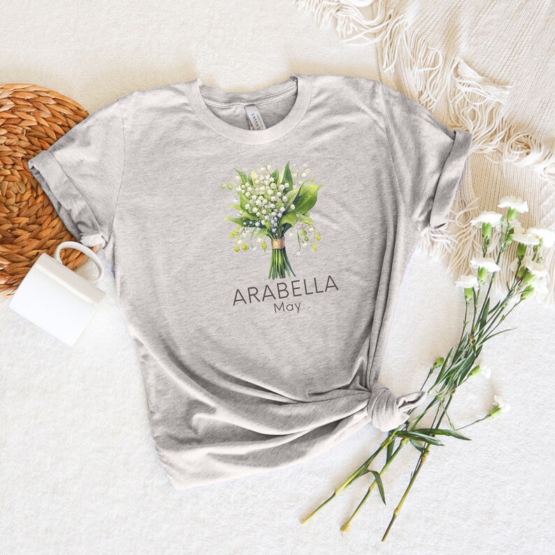 Add a touch of nature to your wardrobe with our customizable design featuring your first name, birth month flower, and birth month. Whether you are a lover of flowers or searching for a unique and meaningful gift for Mothers Day or bridesmaid gifts.