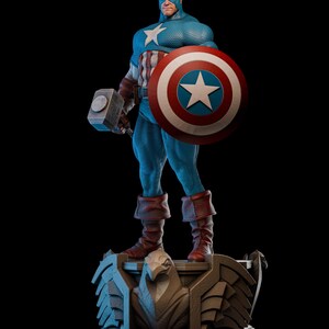 May include: A detailed statue of Captain America in a dynamic pose, holding his shield and a hammer. The figure is clad in a blue and white costume with a star emblem, red boots, and a helmet. The base features an eagle design.