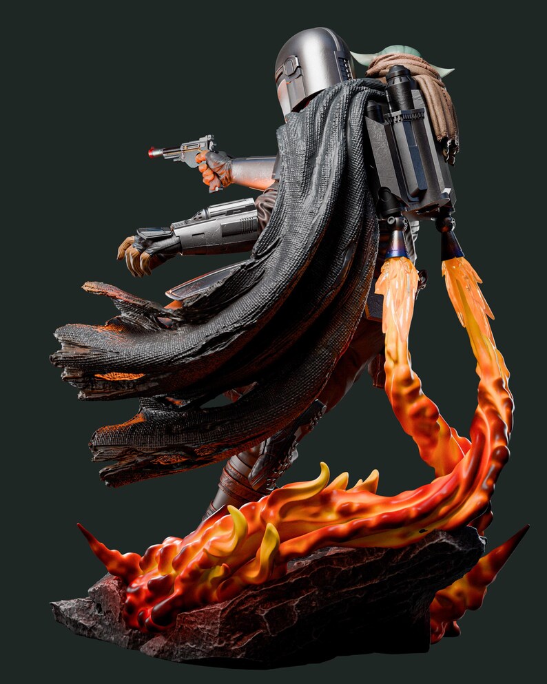 May include: A detailed statue of a character from a science fiction series, clad in silver armour and a black cape, holding a blaster. The figure is mounted on a base with fiery orange and yellow flames, with a small green creature on its back.