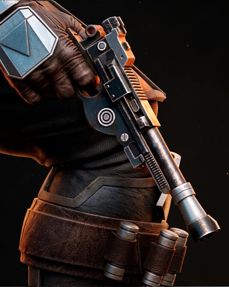 May include: A close-up of a black and silver blaster pistol with orange accents, held by a person wearing a black glove and armor. The pistol has a cylindrical barrel and detailed mechanical components. The person is also wearing brown leather armor.