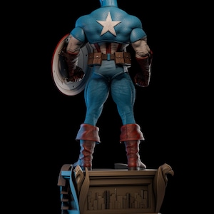 May include: A blue Captain America statue, viewed from the back, with a white star on the back of the costume. The statue is holding a shield and wearing brown boots. The statue is standing on a brown base with a city skyline.