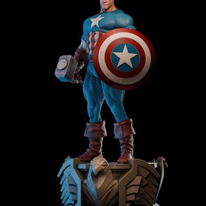 May include: A statue of Captain America, a superhero, stands on a detailed base. He wears a blue and white costume, holding a shield with a white star and a hammer. The statue is set against a black background.