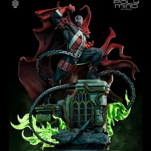 May include: A detailed statue of the comic book character Spawn, posed dynamically atop a gothic-style structure. The figure is clad in a black and red costume with a flowing red cape. Green energy emanates from the base, and a silver chain wraps around the statue.