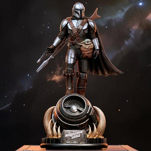 May include: A detailed statue of The Mandalorian holding a weapon, with Grogu in a pouch. The figure is clad in silver and brown armor, standing atop a detailed base. The background is a dark space scene with stars.