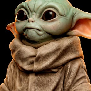 Pu&ograve; includere: Rappresentazione 3D dettagliata di un personaggio con grandi occhi scuri e una fronte corrugata. La figura ha la pelle verde e grandi orecchie, indossa un indumento con cappuccio color beige. Lo sfondo &egrave; nero.