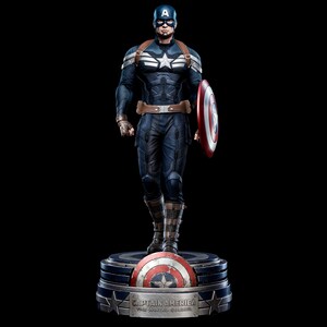 May include: A detailed statue of Captain America in a dynamic pose, holding his iconic shield. The figure is clad in a blue and white costume with a star emblem. The base features the Captain America shield and the text "CAPTAIN AMERICA: THE WINTER SOLDIER".