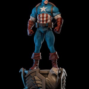 May include: A detailed statue of Captain America, standing on a decorative base. The figure is in a classic pose, wearing a blue and white costume with a star emblem. The statue features a shield and is set against a black background.