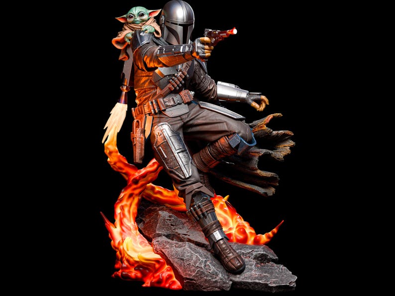 May include: A detailed figurine of The Mandalorian, in silver and brown armour, aiming a blaster with a red beam. Grogu, the Child, sits on his shoulder. The figure is posed on a rocky base with fiery orange and yellow accents, against a black background.