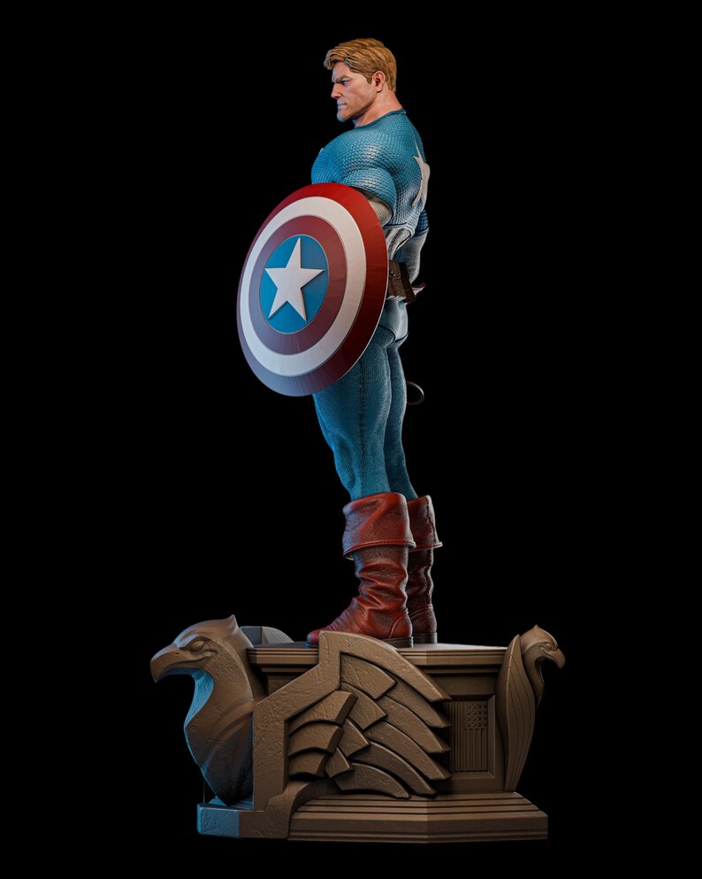May include: A detailed statue of Captain America in a dynamic pose, holding his iconic shield. The figure is clad in a blue and white costume with red boots. The shield features a white star on a blue field, surrounded by red and white rings. The statue rests on a decorative base.