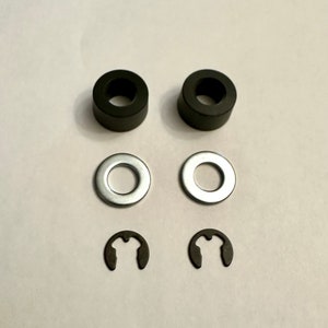 May include: Two black rubber washers, two silver metal washers, and two black metal retaining clips.