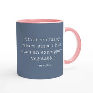 May include: A two-tone ceramic mug with a blue exterior and a pink interior and handle. The mug displays the quote "It's been many years since I had such an exemplary vegetable" attributed to Mr. Collins in white text.