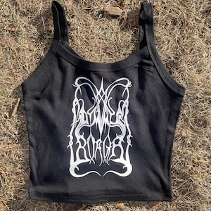 May include: Black crop top with a white graphic design. The tank top has a scoop neck and thin straps. The graphic appears to be a stylized, ornate design with the text "Woven Ruin" in a gothic font.