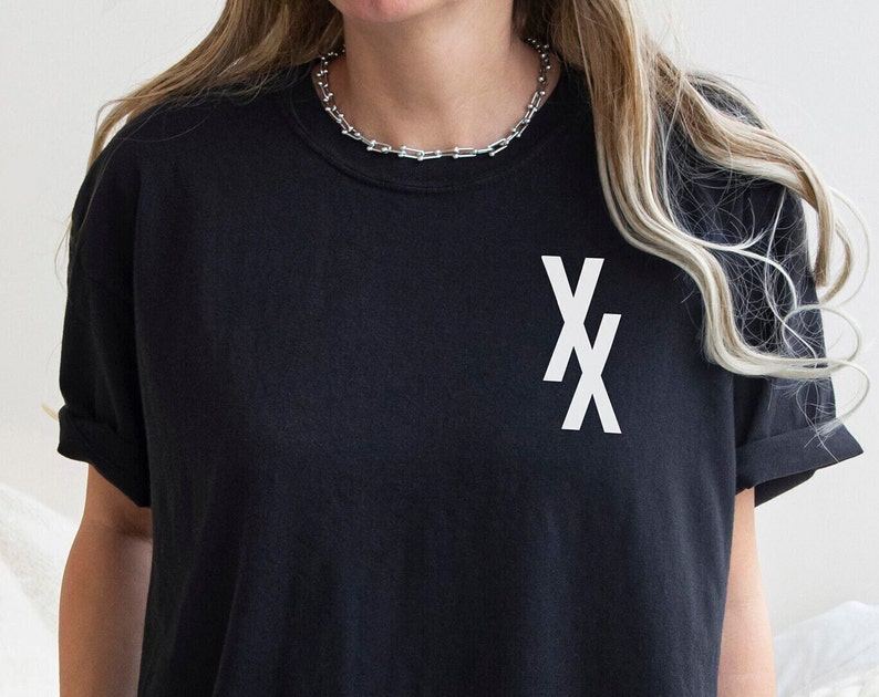 May include: Black t-shirt with a white "XX" graphic on the front.