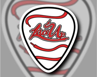 May include: A white guitar pick with a red and black graphic of the word "Lace Up" in a stylized font. The graphic is surrounded by red laces.
