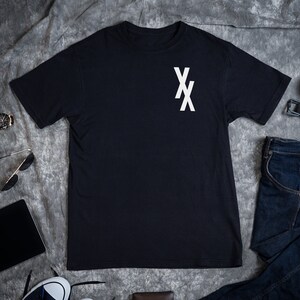 May include: A black t-shirt with a white "XX" graphic on the chest.