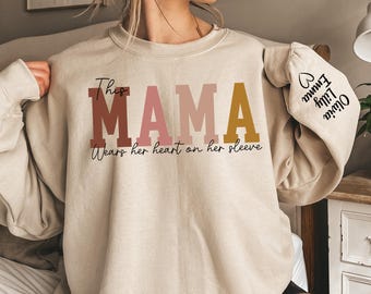 Custom This Mama Wears Her Heart On Her Sleeve Hoodie, Personalized Mom Sweatshirt With Kids Names, Cute Momma Outfit, Mothers Day Gifts