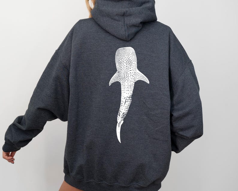 May include: A dark gray hooded sweatshirt with a white whale shark graphic on the back.