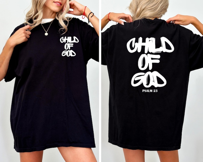 May include: Black t-shirt with the text "CHILD OF GOD" in white on the front and back. The back of the shirt also includes "PSALM 23" in white. The shirt has a crew neck and short sleeves.