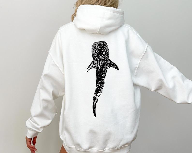 May include: White hoodie with a black and white whale shark graphic on the back.