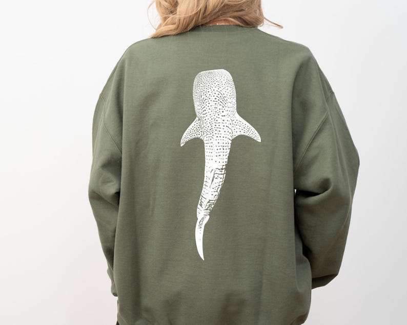 May include: A green sweatshirt with a white whale shark graphic on the back.