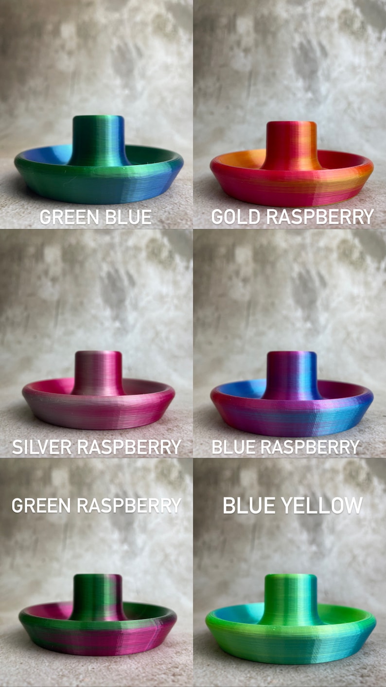 May include: A selection of 3D-printed ashtrays in various colour combinations. Each ashtray has a circular base with a central post. The colour schemes include green and blue, gold and raspberry, silver and raspberry, and blue and yellow.