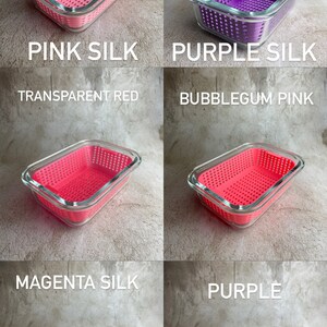 May include: Rectangular glass containers with coloured, perforated plastic inserts. The containers are in various shades of pink and purple, with text labels including "PINK SILK," "PURPLE SILK," "TRANSPARENT RED," "BUBBLEGUM PINK," "MAGENTA SILK," and "PURPLE."