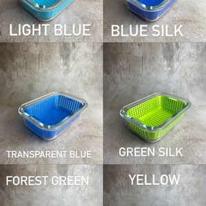 May include: A selection of rectangular food storage containers in light blue, blue silk, transparent blue, green silk, forest green, and yellow. Each container has a clear glass lid and a perforated plastic base. The colour of each container is indicated by text on the image.