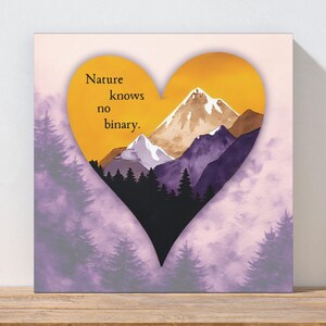 May include: Square canvas art featuring a heart-shaped design with a mountain landscape. The heart is filled with a sunset scene and the text "Nature knows no binary." Purple and green trees frame the heart.