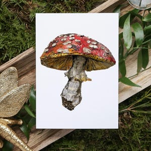 May include: A red and white mushroom with white spots, made from paper, on a white background.