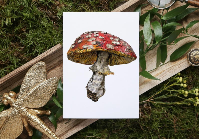 May include: A red and white mushroom with white spots, made from paper, on a white background.