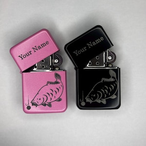 May include: Two open lighters, one pink and one black, with the text "Your Name" on the lid. Each lighter features a detailed fish illustration. The pink lighter has a silver hinge, and the black lighter has a black hinge.