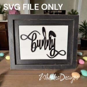 May include: A framed wooden sign with the word "Bunny" in a black cursive font. The sign has a white background with horizontal wooden slats and a dark gray frame. The text "SVG FILE ONLY" is at the top.