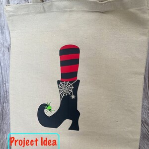 May include: A white canvas tote bag with a black witch's boot design. The boot has a red and black striped top and a spider web with a spider on it. The text "Project Idea" is printed on the bottom of the bag.