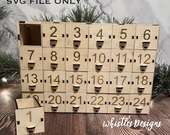 May include: A wooden advent calendar with 24 numbered drawers. The drawers are arranged in a rectangular shape and are labeled with the numbers 1 through 24. The calendar is made of light brown wood and has a rustic look.