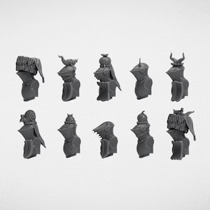 Könnte beinhalten: Eine Sammlung von zehn grauen Miniatur-Ritterrüstungen, jede mit einzigartigen Helmdesigns. Die Helme weisen verschiedene Verzierungen auf, darunter Hörner, Federn und Fell, vor einem schlichten weißen Hintergrund.